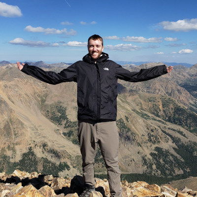 Teddy standing on a mountain peak