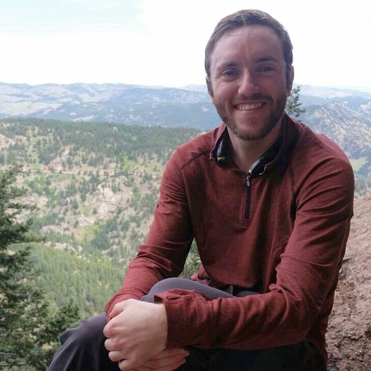 Teddy Williams (author) smiling with mountains in the background